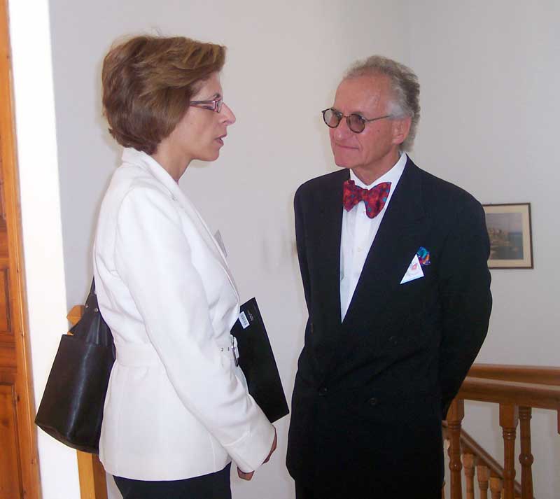 Dr. Kivitz speaking with Stella Kyriakedes from Cyprus near a staircase in Ormylia, Greece.